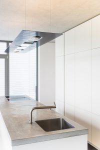 Modern contemporary kitchen with concrete kitchen counter.